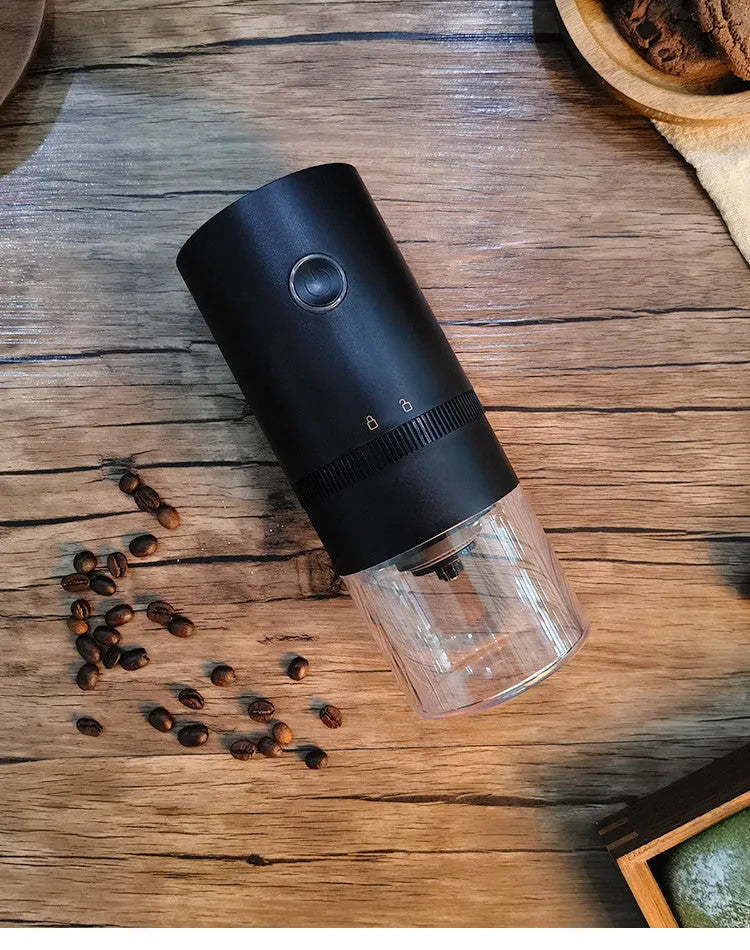 Portable black electric coffee grinder with transparent chamber and USB-C charging cable
