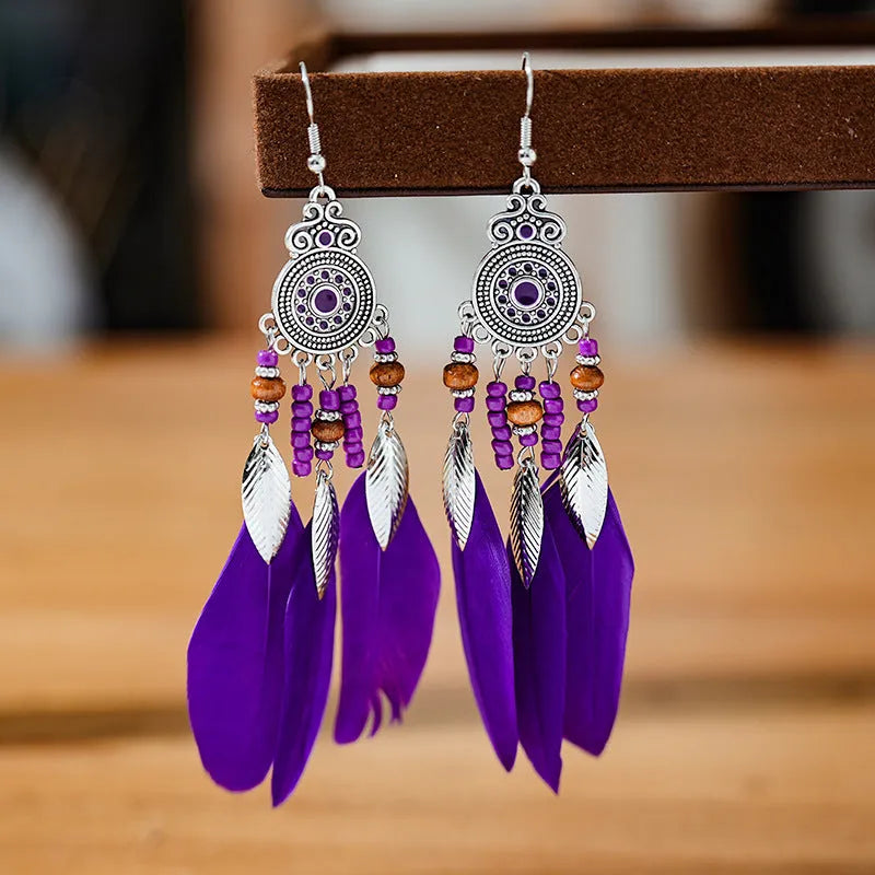 Round drop feather earrings in alloy with electroplated finish showing leaf shape and pattern details