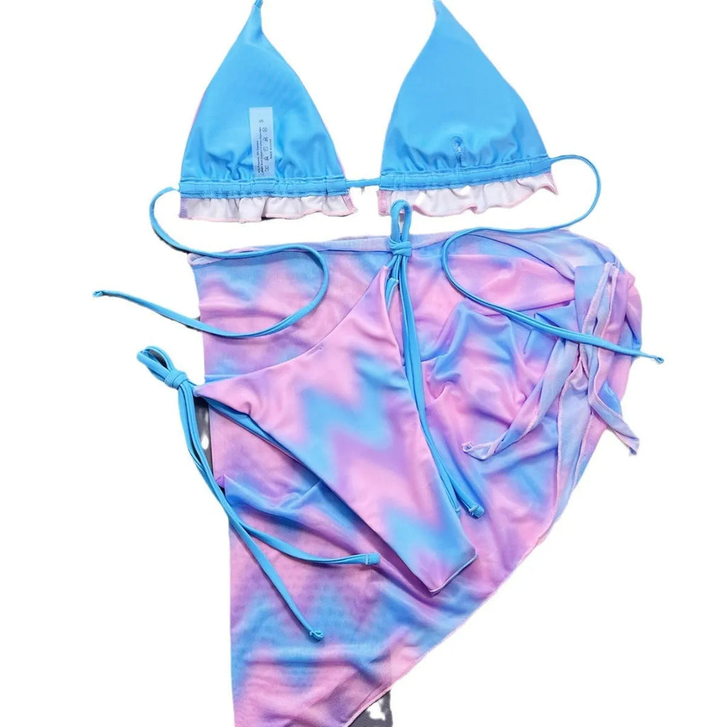 Women's split tie-dye bikini swimsuit set with matching skirt on mannequin