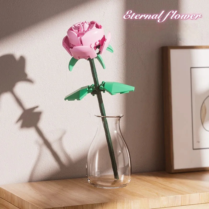Rose assembled from small particle plastic building blocks in pink, red, or blue