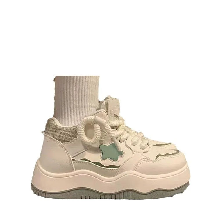 Women's green platform sneakers with round toe and lace-up closure on rubber sole