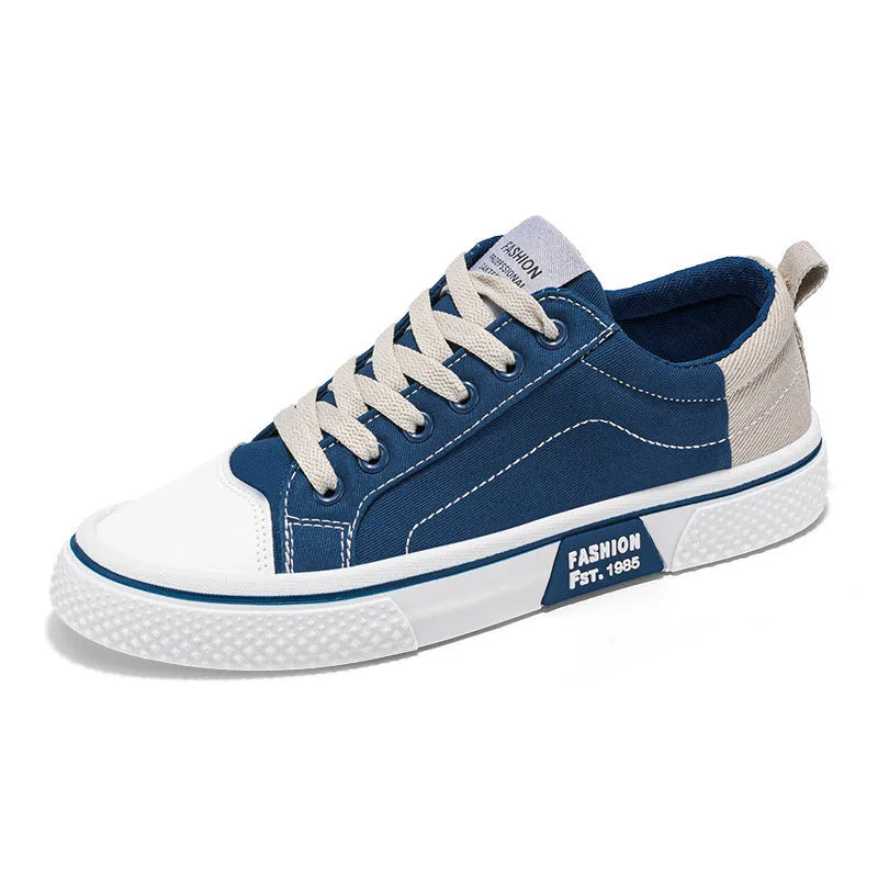 Men's low-top canvas shoes in blue with white sole and lace-up front, on a grey background.