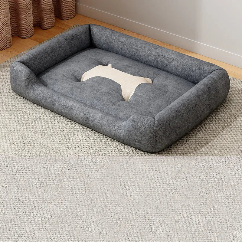 A soft, padded pet sofa mat shown in one of five colours (Black, Grey, Red, Yellow) next to a dog, illustrating its use as a furniture-protecting bed.