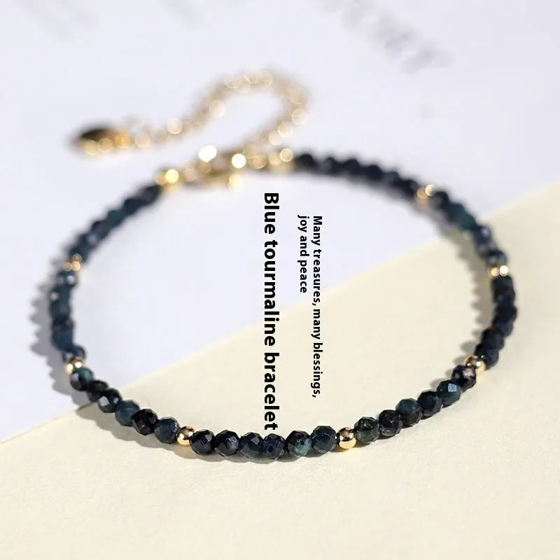 Women's blue tourmaline bracelet with 3mm beads and spacer bead design.