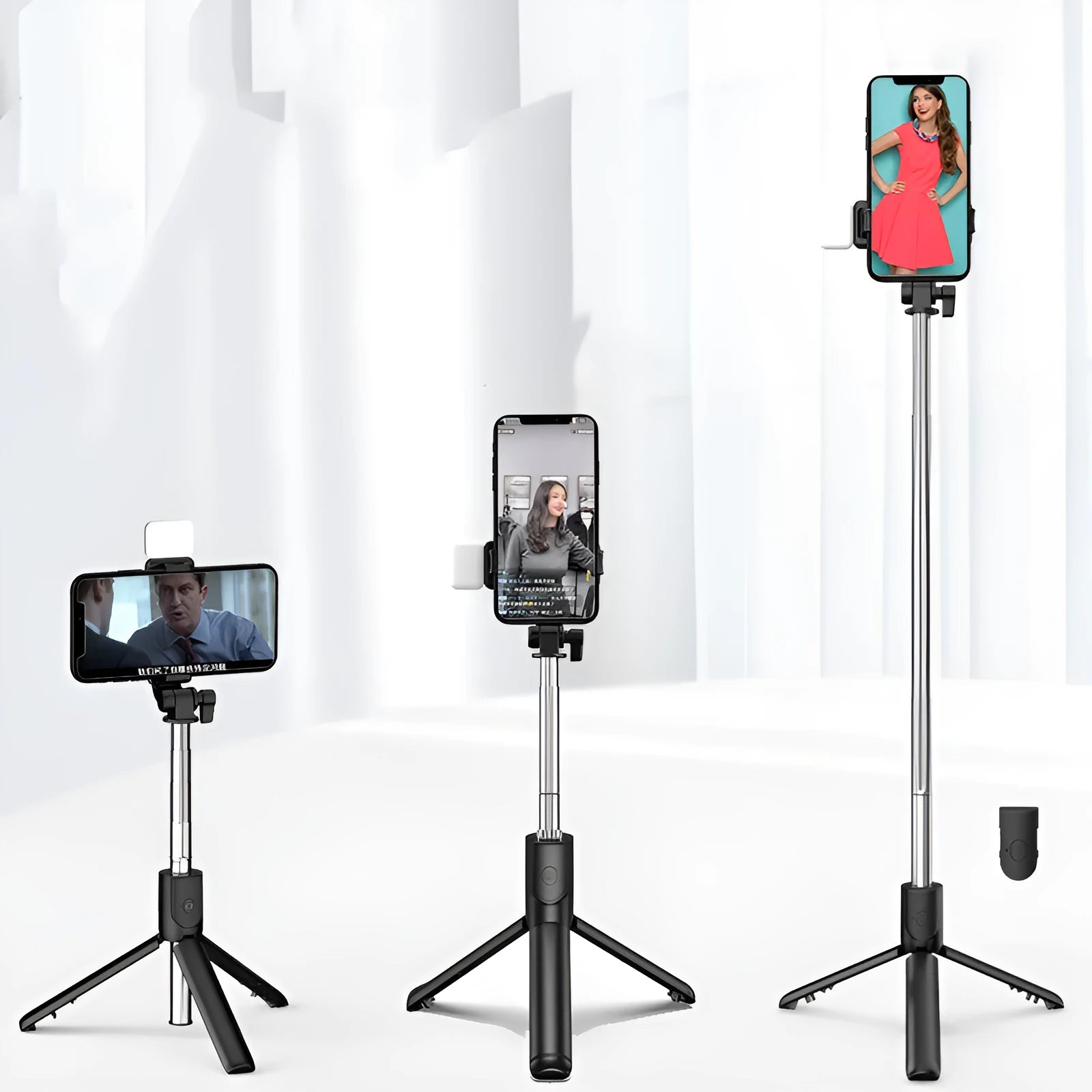 Black aluminium Bluetooth selfie stick with extended tripod legs and a phone mounted in the 360-degree rotating holder.