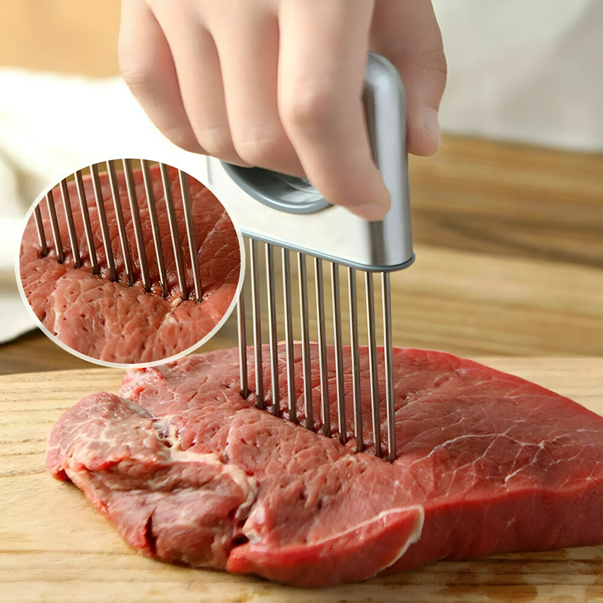 Stainless steel onion holder slicer with sharp prongs and a separate finger guard on a kitchen counter.
