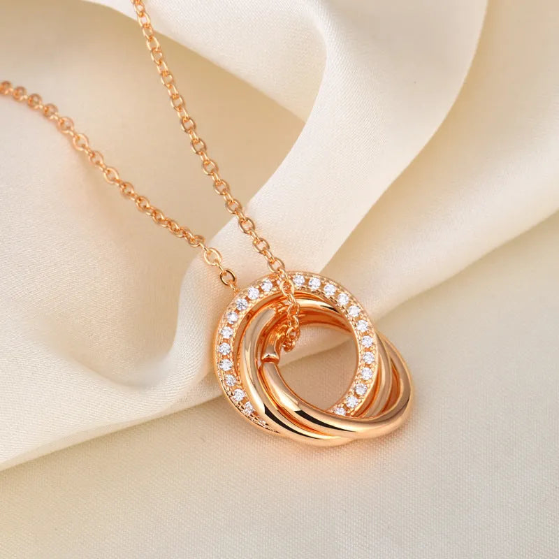 Geometric copper necklace with micro-inlaid interlocking three rings in champagne gold on woman