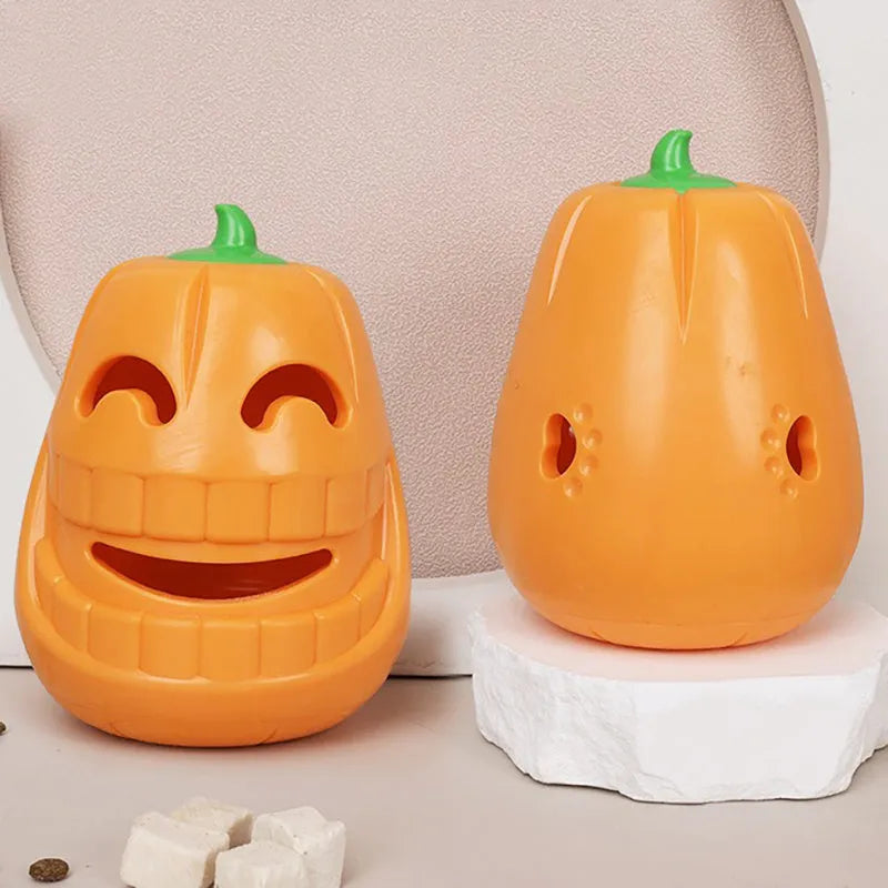 Orange Halloween pumpkin-shaped dog chew toy with a treat-dispensing funnel hole.