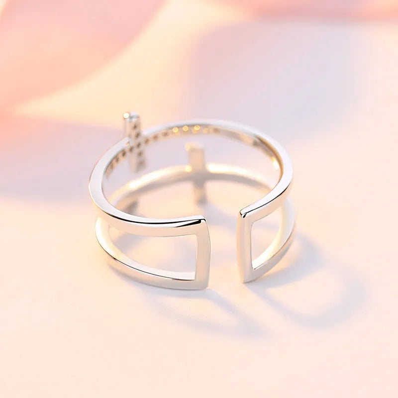 Geometric adjustable copper ring with a white gold finish and a central zircon stone in a sterling silver setting.