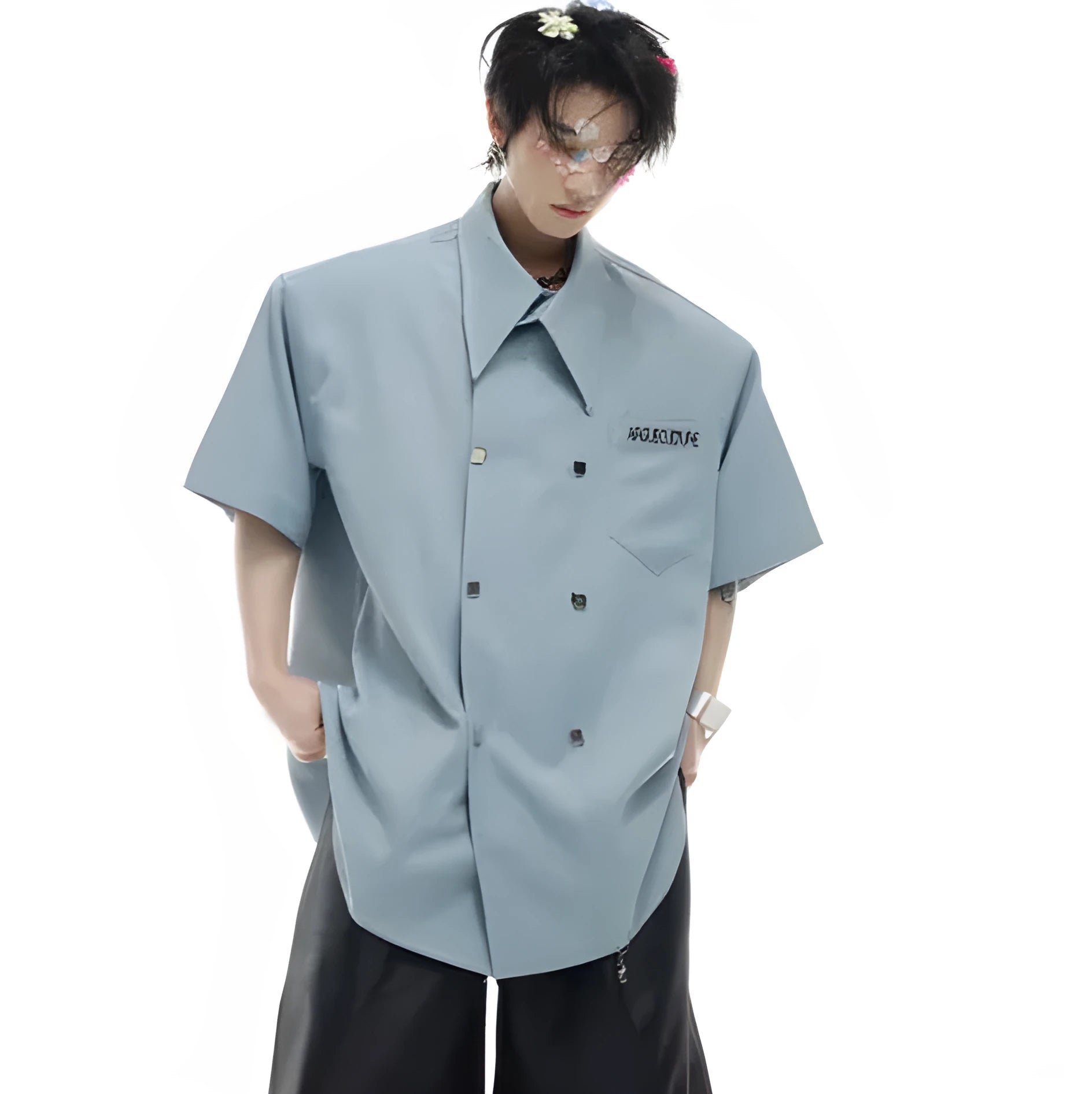 A man's loose-fitting casual short-sleeved shirt in blue with metal buttons and contrast panel detail.
