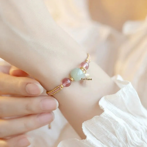 Adjustable red rope bracelet with strawberry quartz beads, showcasing national style design.