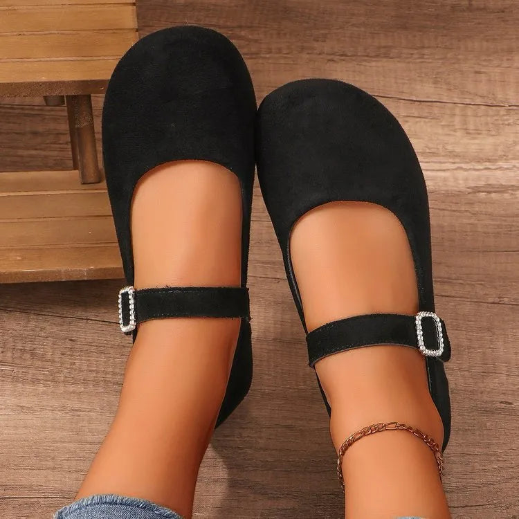 Black canvas low-top flat fisherman shoes with a rubber sole on a plain background.