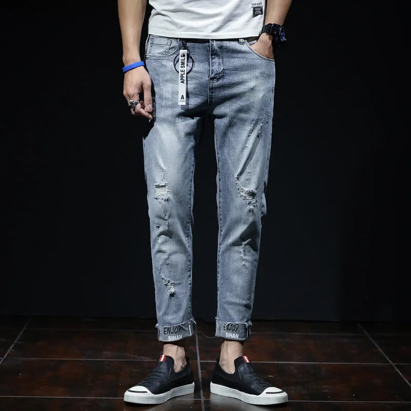 Light blue ripped jeans with straight leg, mid waist, and cropped length for youth