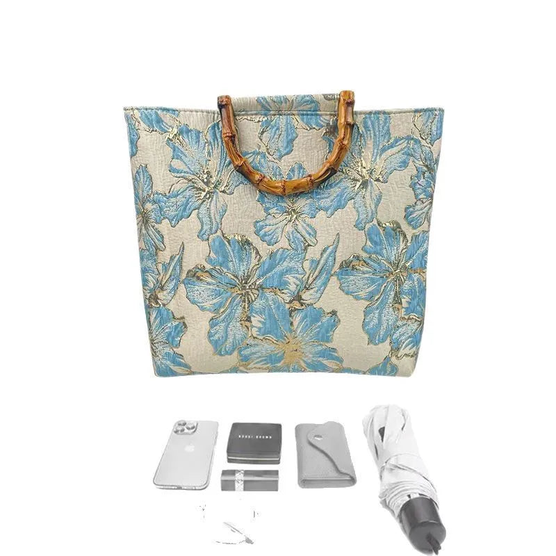 Light blue women's canvas bag with gold bronzing flower pattern showing double shoulder straps and square shape