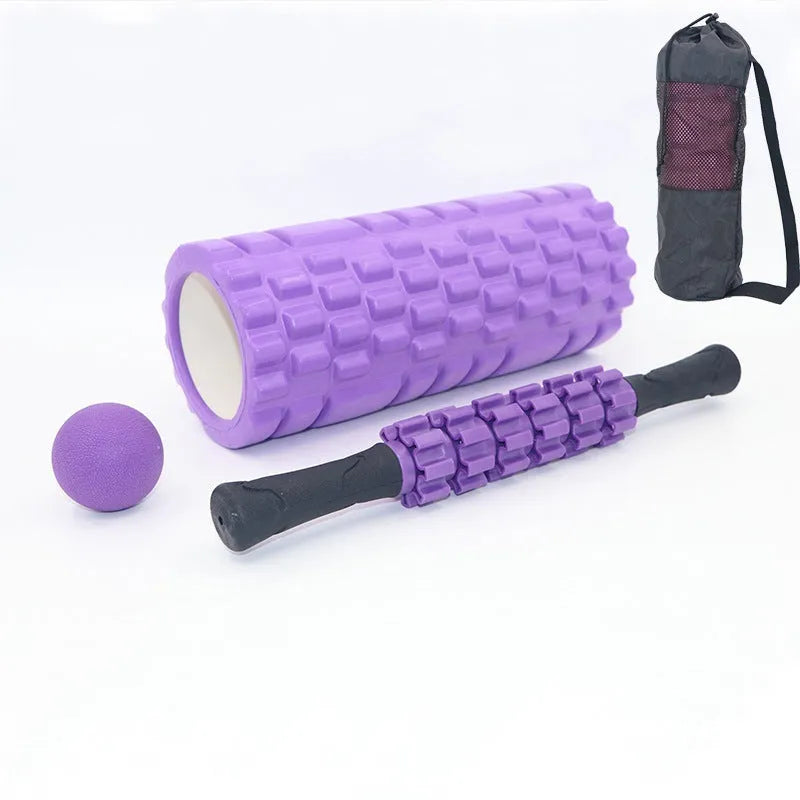 Black 33cm long foam roller massage stick with gear bar design on a grey background.