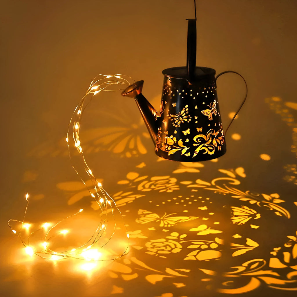 Solar garden lamp with iron butterfly pattern, emitting warm white light.