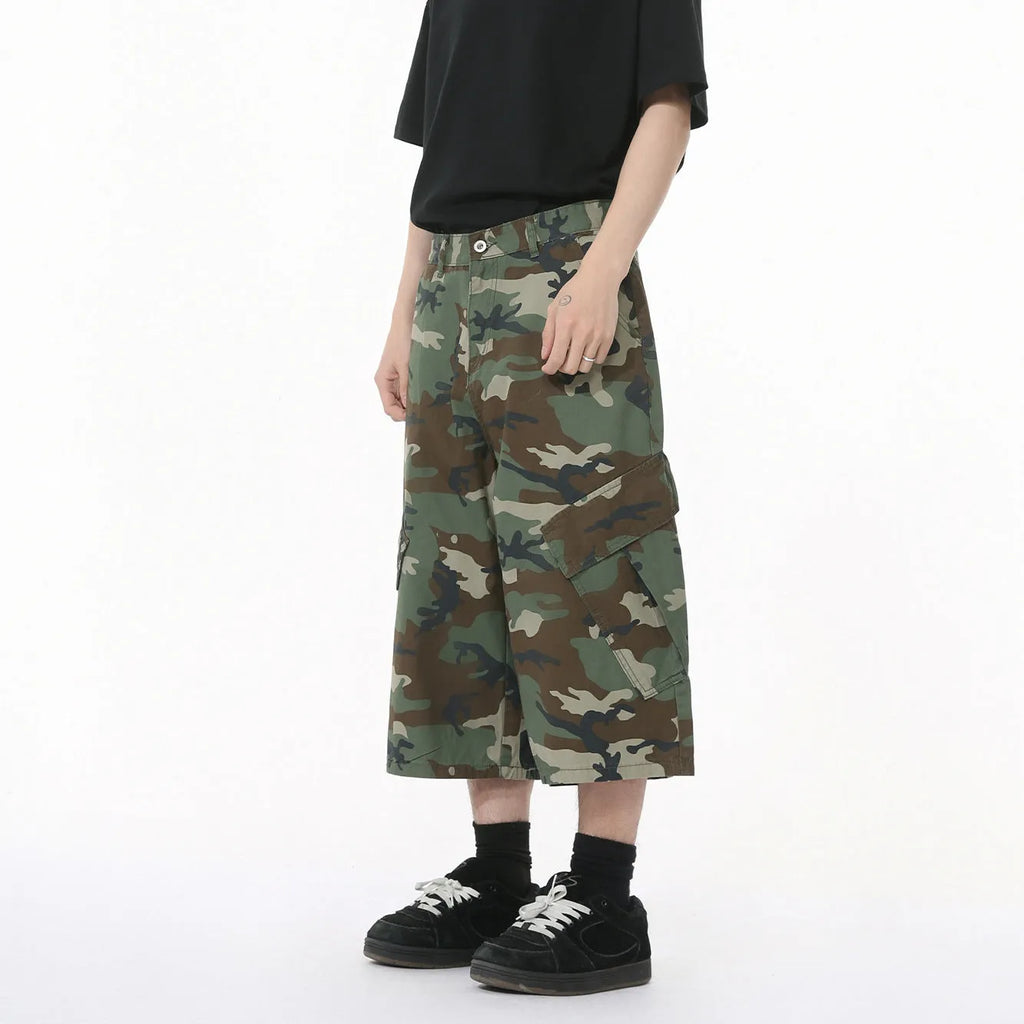 Man wearing loose camouflage print cotton jeans with wide legs and side stitching.