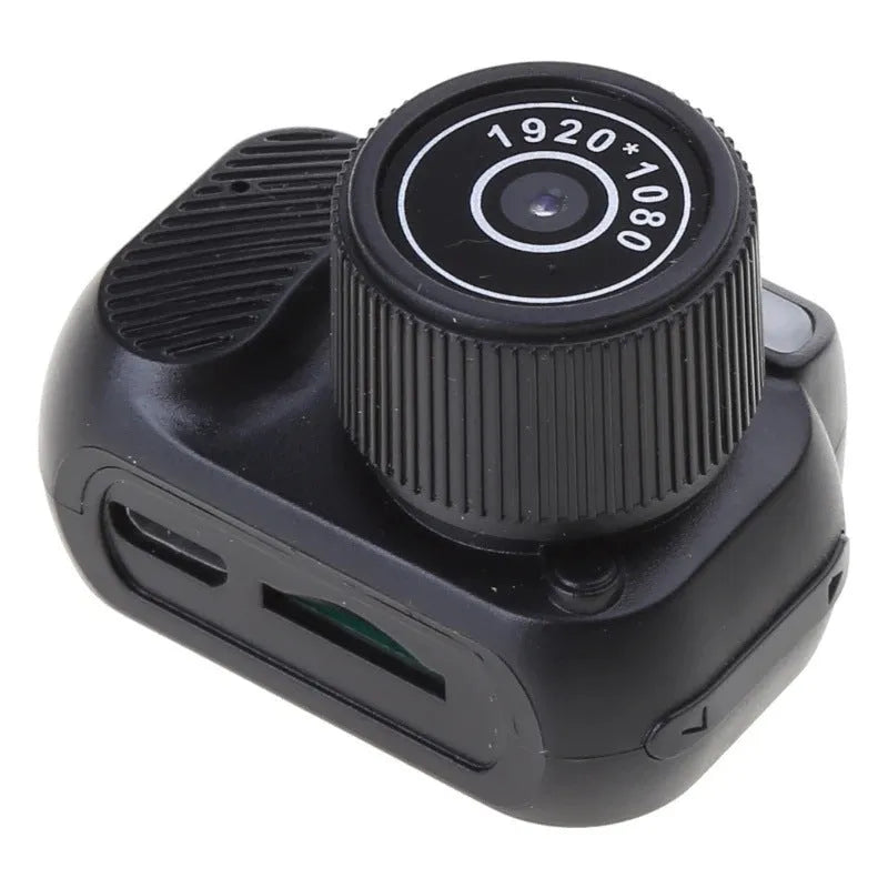 Black retro-style mini digital video camera with small screen shown on a table.