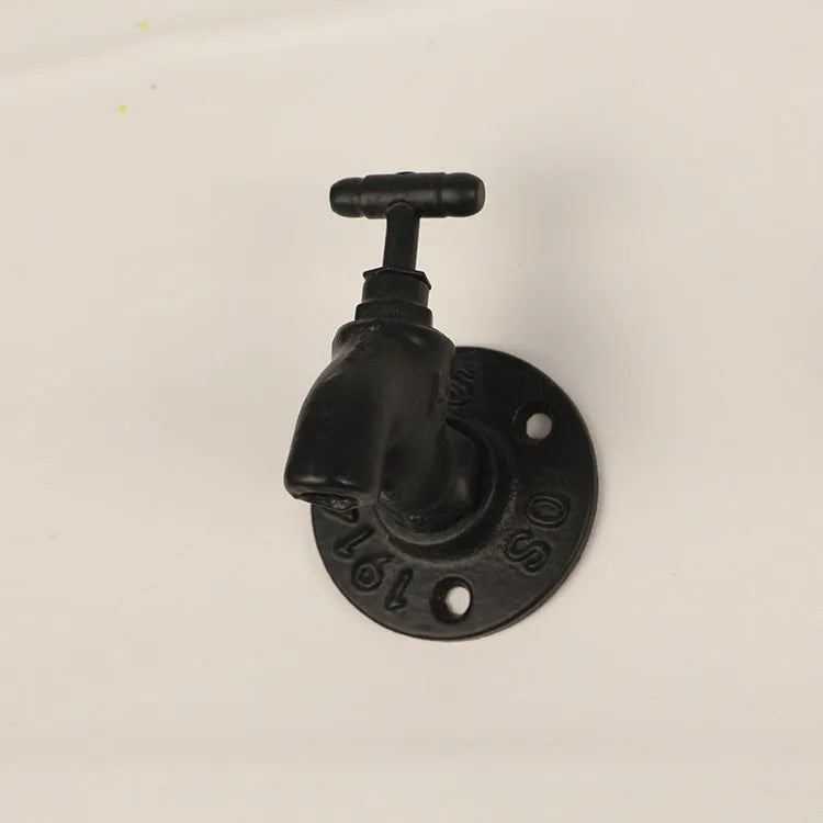 Metal water pipe style wall hanging hook in a choice of colours on a white wall.