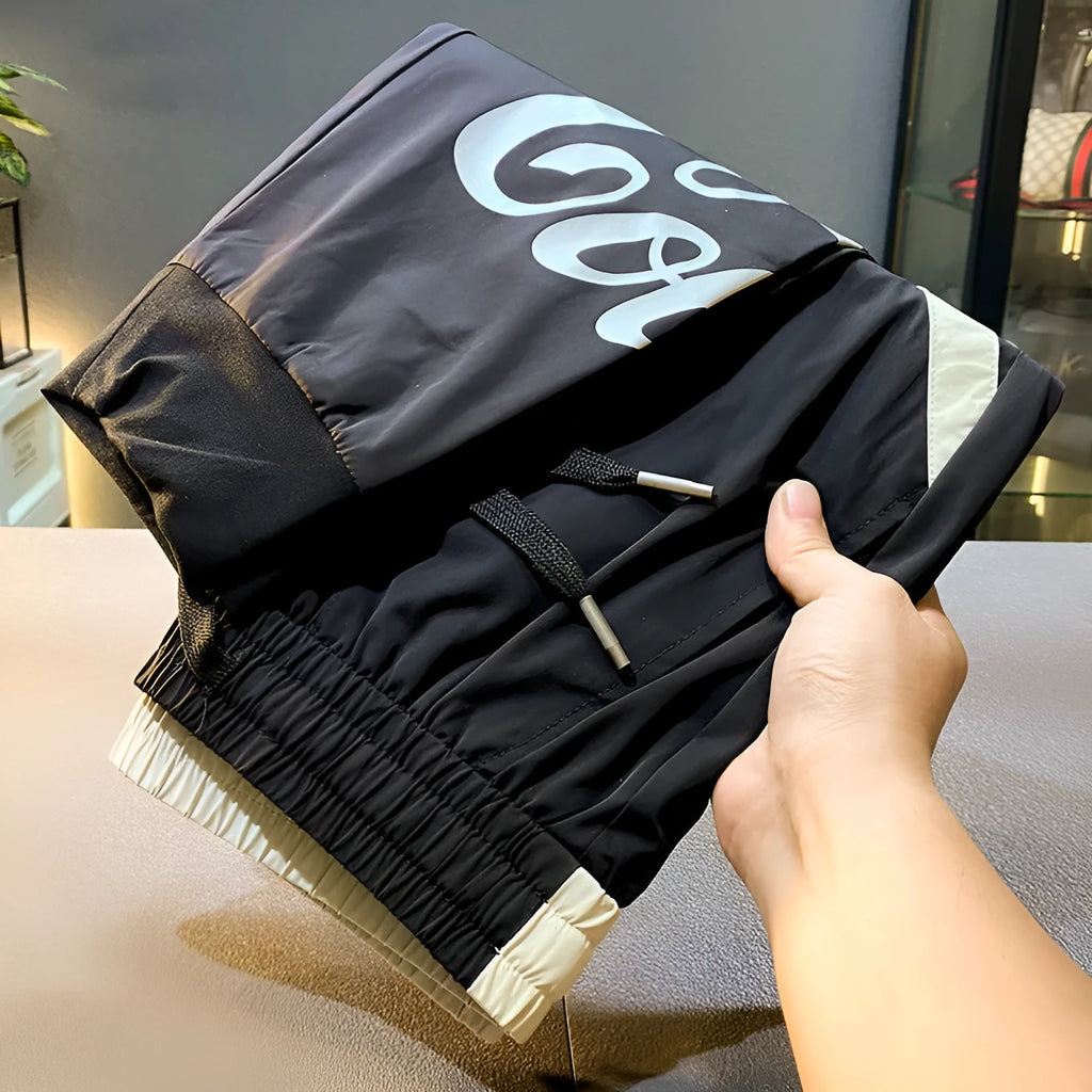 Men's black ultra-thin ice silk ankle banded casual trousers showing cropped design with elastic cuffs