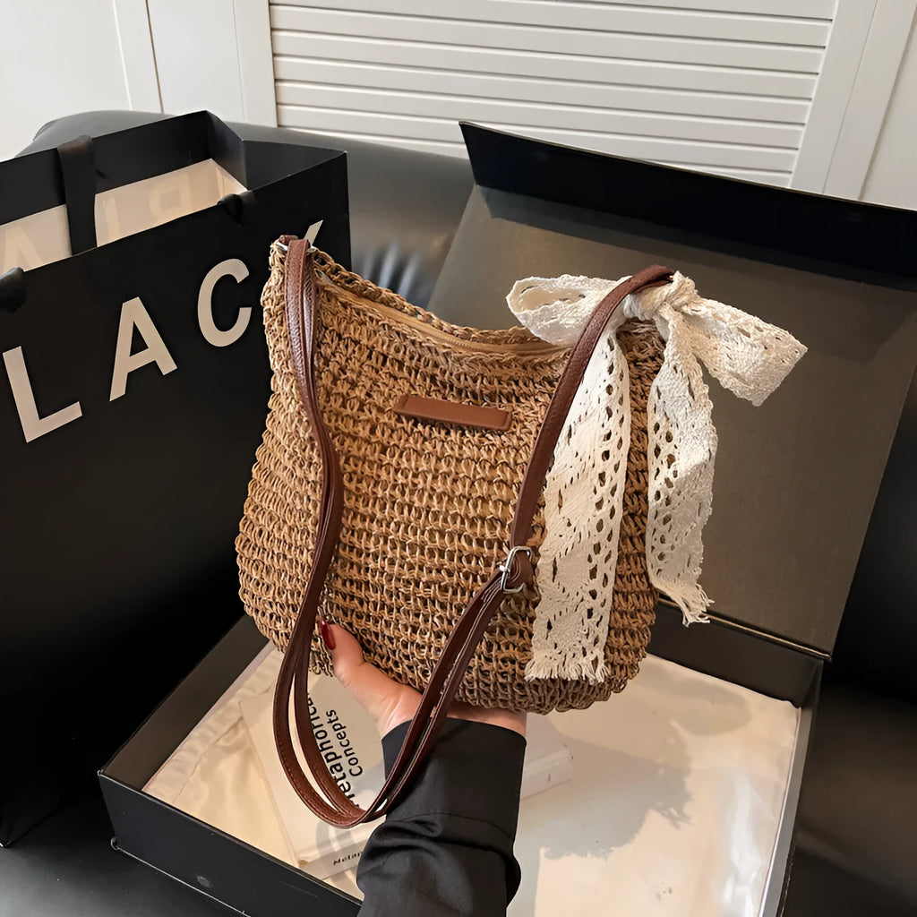 Women's woven straw messenger bag with hollowed design in khaki colour showing vertical square shape