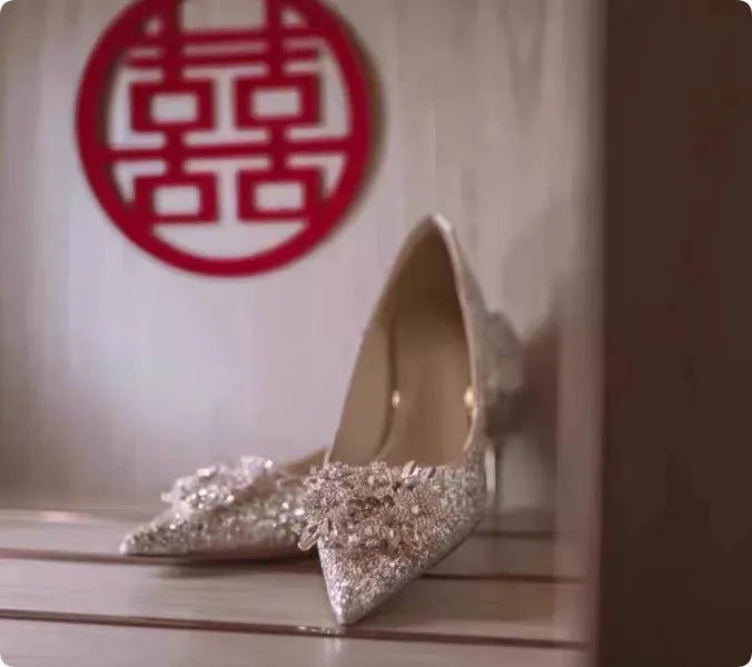 Champagne coloured women's wedding shoes with pointed toe, rhinestone details, and a fine heel.