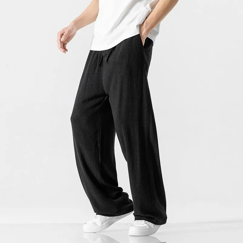 Men's beige linen-blend cropped trousers with a drawstring waist on a plain background.