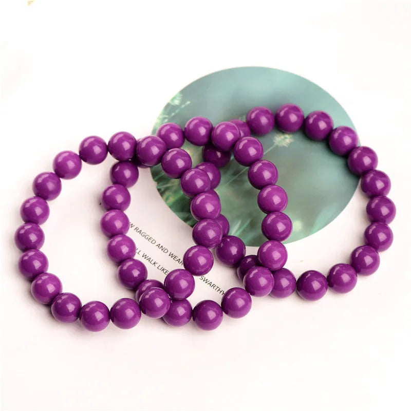 Jiuya brand purple mica crystal bracelet with polished beads on a wrist.