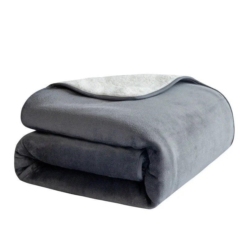 Grey lambswool waterproof dog blanket on a sofa, showing its cloth texture and size.