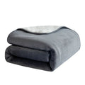 Grey lambswool waterproof dog blanket on a sofa, showing its cloth texture and size.