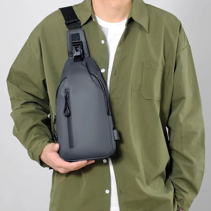 Black sling crossbody backpack for men with zip closure and soft handle, solid colour