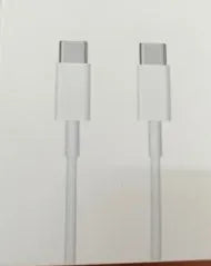 White 20W USB-C Power Delivery fast charger with British plug and coiled USB-C cable.