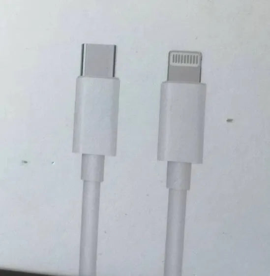 White 20W USB-C Power Delivery fast charger with British plug and coiled USB-C cable.