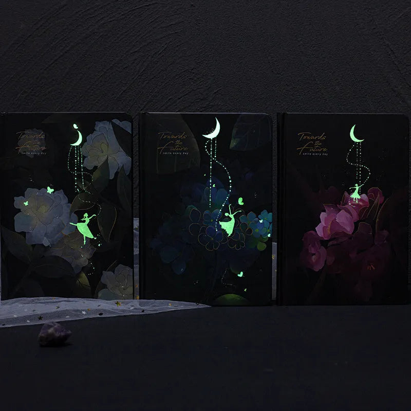 A5 notebook with luminous holographic cover open to show colour illustration on inside pages.