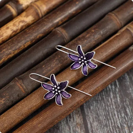 A pair of purple flower-shaped alloy earrings with a retro elegant design.