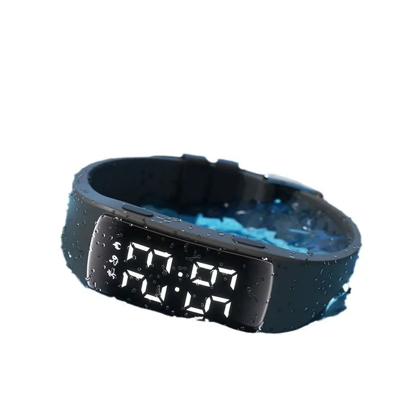 Smart vibration alarm watch with LED display and coloured silicone strap on a wrist