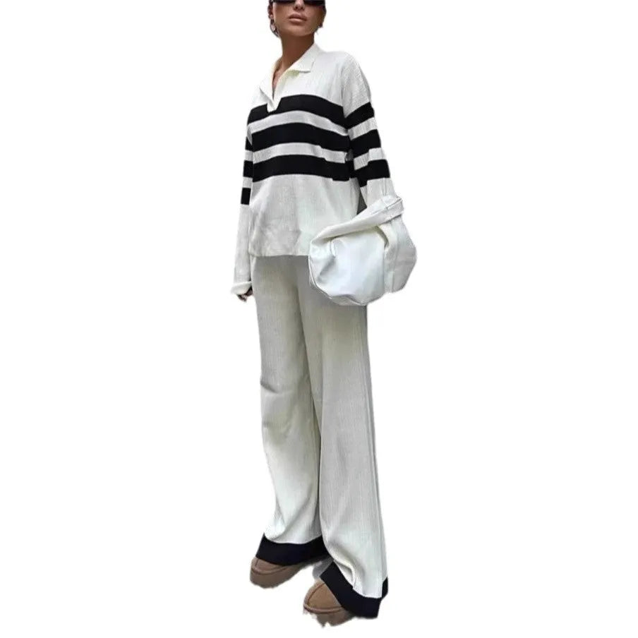 Woman wearing a black and white striped long-sleeve polo shirt and matching black casual trousers from a two-piece knit set.