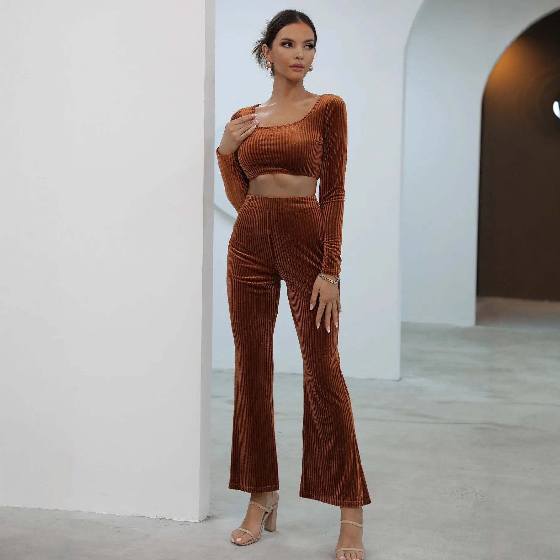 Caramel coloured long sleeve sweater and matching trousers set on a hanger.