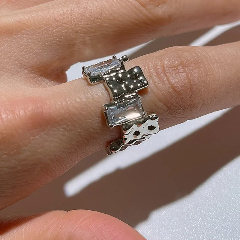 Silver geometric ring with cross zircon design and open gemstone setting