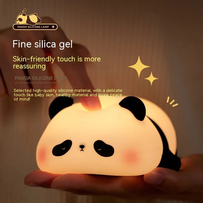 Cartoon panda silicone night light with USB charging cable on wooden surface