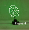 Minimalist white bamboo-shaped desktop lamp with a green glow, shown in two size options.