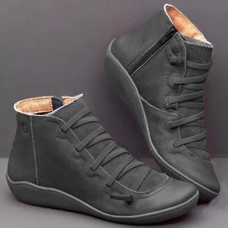 Women's casual flat ankle boots in artificial PU leather with a round toe and wedge rubber sole.