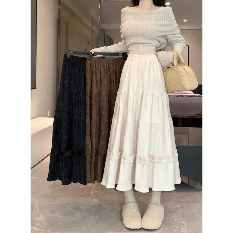 Corduroy midi A-line skirt with elastic waistband in milk white, shown on a model.