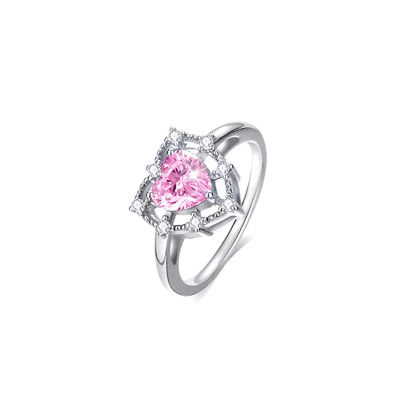 Silver heart-shaped ring with inlaid zircon and hollow-out band in white gold colour
