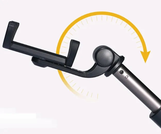 Black Bluetooth selfie stick with tripod base and remote control extended next to smartphone