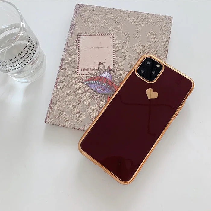 Simple solid-colour TPU back cover case for iPhone on a table, showing blue colour option.
