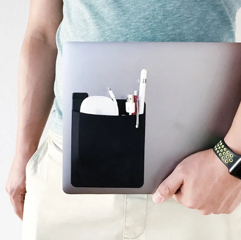 Black adhesive Lycra laptop back storage bag 15x12cm with pen loop, attached to laptop showing items inside