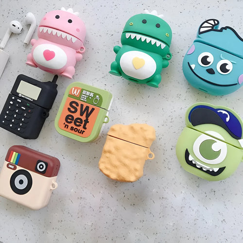 Green silicone AirPods 1/2 generation case with a cartoon animal design on a table.