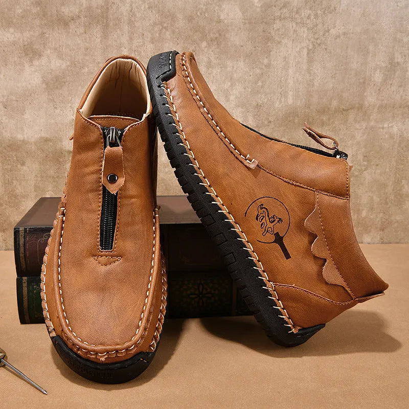 Men's black slip-on loafers with round toe and rubber sole on a plain background.