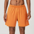 Men's double-layer quick-dry running shorts in brick red colour on a mid-waist fit model.